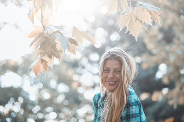 Young woman enjoying in autumn colored nature.