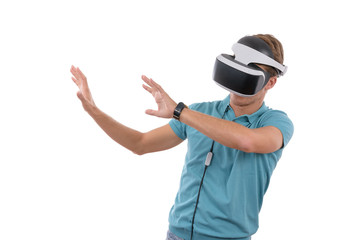 Caucasian young boy playing with virtual reality glasses dressed in a blue polo shirt isolated in white background