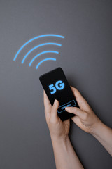 Hands holding smartphone connecting to 5g internet, flat lay on gray background