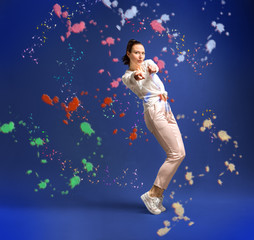 Fototapeta na wymiar young and beautiful dancer posing in studio at colored background