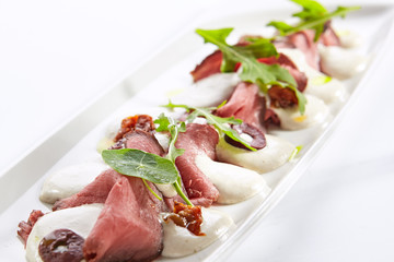 Beef vitello tonnato platter closeup