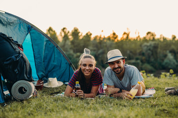 couple having fun camping by the lake