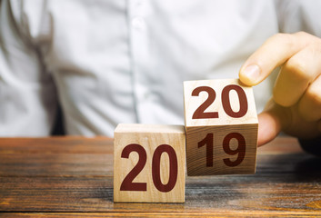 Two wooden blocks with numbers 2019 and 2020. The concept of the beginning of the new year. New...