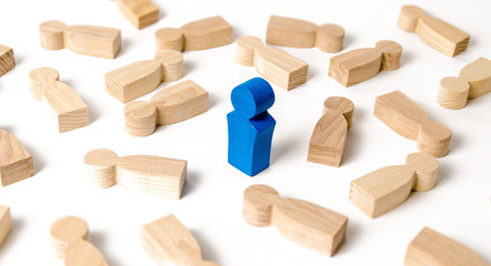 Blue man figure stands among the many lying figures of people. The concept of selectivity. Leader, leadership, head of organization. Organization business processes, team building. example to follow