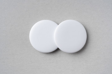 top view of white badge on grey background