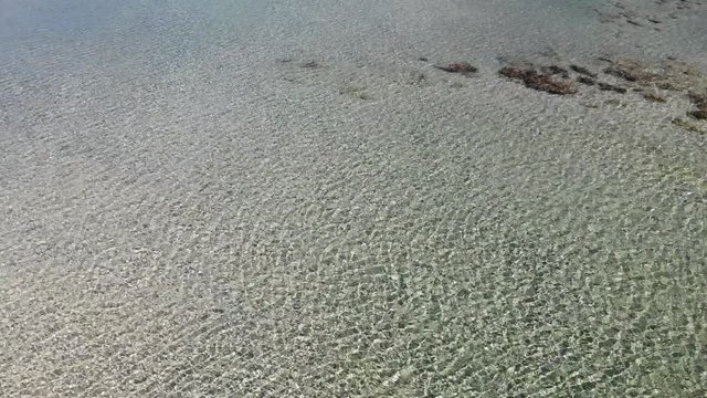 Seawater and pink sand on the Elafonisi lagoon, Crete, Greece. Shallow water on the beach in the summer.