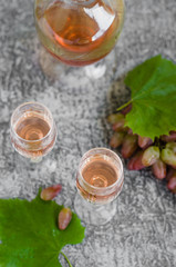 Traditional Italian grappa or liquor and grape.  Wine and grape.