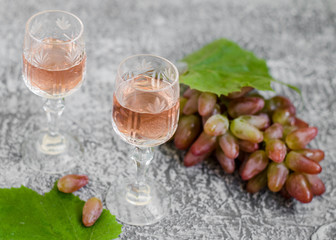 Traditional Italian grappa or liquor and grape.  Wine and grape.