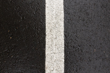Fototapeta premium Wet asphalt background. Road marking. Black asphalt background.