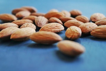 almond close up on blue surface.