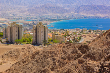Fototapeta premium seaport resort Israeli city Eilat buildings near Gulf of Aqaba top vie landmark photography from desert mountains high point 