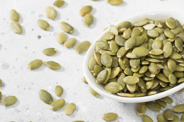 Pumpkin seeds in a white bowl