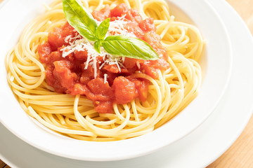 close up on dish with spaghetti tomato and basil