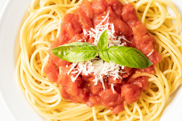 close up on dish with spaghetti tomato and basil