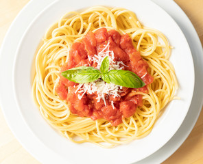 close up on dish with spaghetti tomato and basil