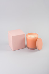 Candle in orange glass with a lid studio shot mock-up