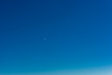 blue sky with a plane and the moon