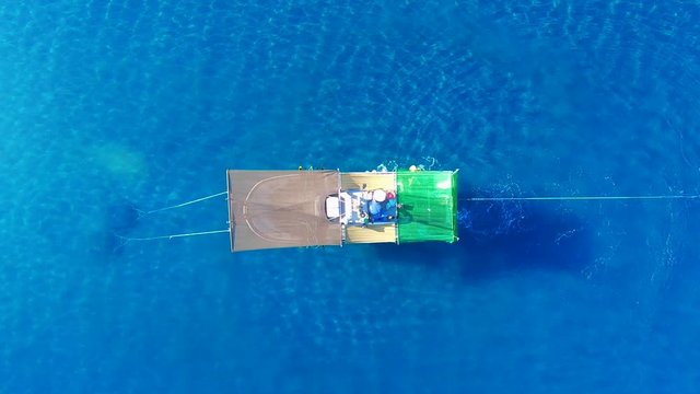 Aerial zenith view of a Shrimp boat in the Mediterranean, in front of the coast of Malaga. Picking the typical "concha fina" Malaga&rsquo;s clam (Cytherea chione). 