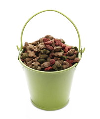 Pet food, granules in metal bucket isolated on white background