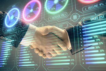 Multi exposure of business graph on abstract background with two men handshake. Concept of success