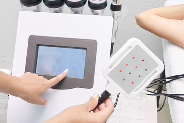 Laser lipo equipment. Cosmetic fat reduce treatment. Woman in medicine salon. Anti cellulite procedure