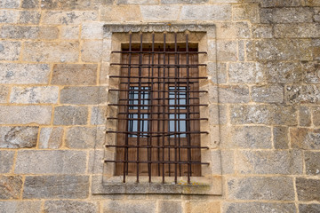 Fototapeta na wymiar Ventana enrejada en pared de sillares de Granito. Monasterio de San Salvador de Celanova. Ourense, Galicia. España
