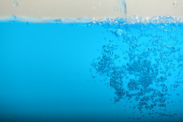 Blue water and air bubles on white background