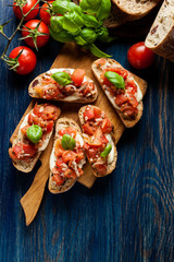 Italian bruschetta with roasted tomatoes, mozzarella cheese and - obrazy, fototapety, plakaty