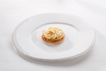 bun with cottage cheese vatrushka pastry on white plate isolated on white background