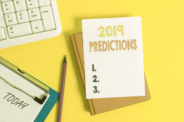Writing note showing 2019 Predictions. Business concept for statement about what you think will happen in 2019 Pile of empty papers with copy space on the table