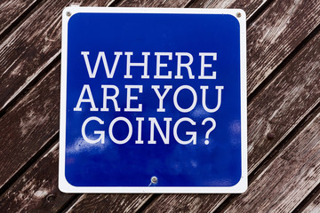 Handwriting text writing Where Are You Goingquestion. Conceptual photo used to ask someone the destination headed to Empty blue board with copy space above wooden background