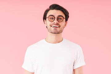 Image of handsome cheerful man wearing eyeglasses smiling and looking at camera