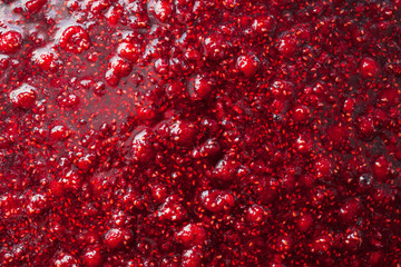 beautiful glare texture of raspberry jam closeup, food background - obrazy, fototapety, plakaty