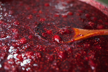beautiful glare texture of raspberry jam closeup, food background