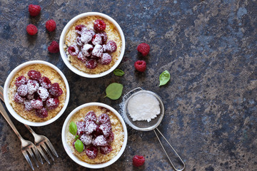 Cheesecake - The classic dessert cheese cream with raspberries. Dessert on the kitchen table. Souffle with cream and berries.