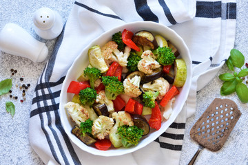 Many different vegetables and spices baked in the oven. View from above.
