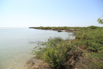 Thatta, Pakistan - April, 2018 : Sea Erosion in Keti Bandar Area of Thatta Sindh, Boats Fisher Man in Sea, Poor Huts Condition of People 