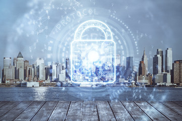 Lock icon hologram on city view with skyscrapers background multi exposure. Data security concept.