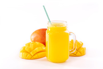 Fresh tropical mango juice with beautiful diced pulp and striped paper straw isolated on white background table, close up, cut out, clipping path.