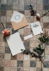 wedding invitation card, wax seal, vase, sea stone, flowers. Wedding calligraphy vintage top view