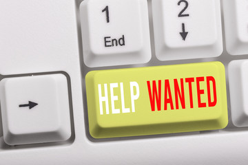 Writing note showing Help Wanted. Business concept for An ad in the paper an employer places to...