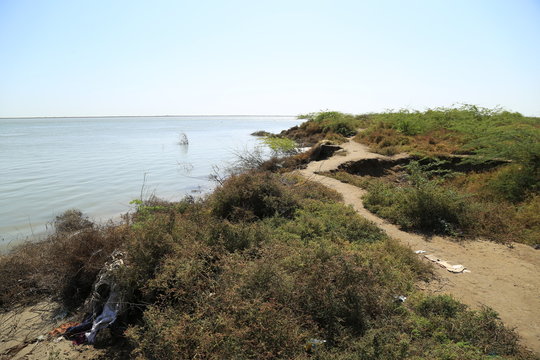 Thatta, Pakistan - April, 2018 : Sea Erosion in Keti Bandar Area of Thatta Sindh, Boats Fisher Man in Sea, Poor Huts Condition of People 