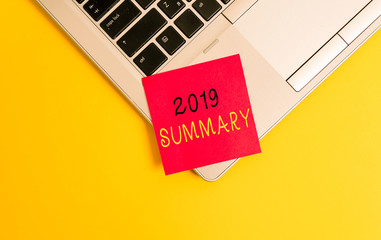 Writing note showing 2019 Summary. Business concept for brief comprehensive especially covering the main points of 2019 Metallic trendy laptop blank sticky note empty text colored background