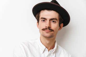 Portrait closeup of beautiful mustached man wearing hat and shirt looking at camera