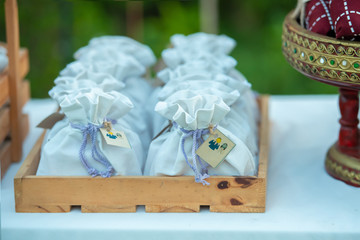 Wedding favors placed on the white table.