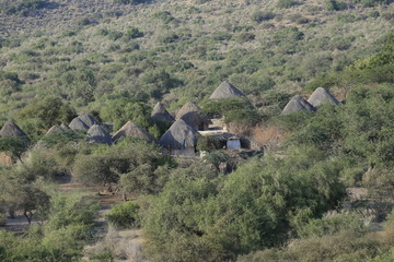 Tharparkar Sindh, Pakistan - March, 2019: View of Green Thar Desert Poor hut house, Women Children Colourful Dress, Barren land Drought in Thar Desert