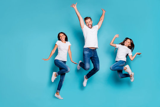 Full length body size photo of jumping enjoying nice glad family cute wearing white t-shirts jeans denim while isolated with blue background