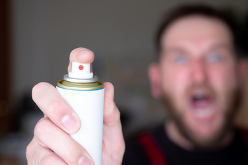 screaming man in the background out of focus foreground aerosol can gas from insects
