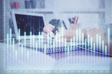 Financial graph displayed on woman's hand taking notes background. Concept of research. Double exposure
