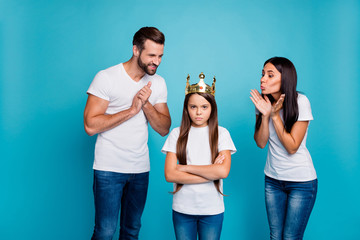 Daddy mommy proud of small lady wearing diadem hate being princess isolated blue background © deagreez